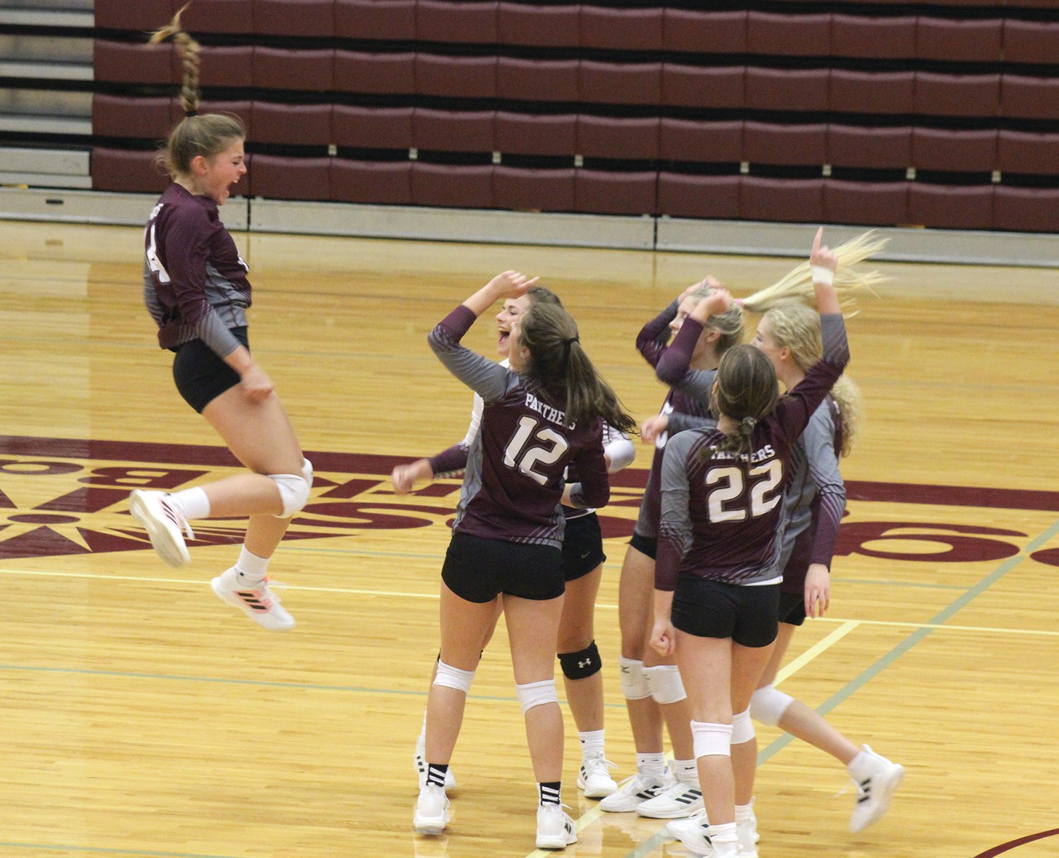 Mountain Grove’s Reagan Hoerning celebrates with her teammates after an ace against Strafford.